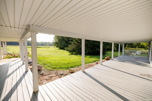 wooden terrace with a yard