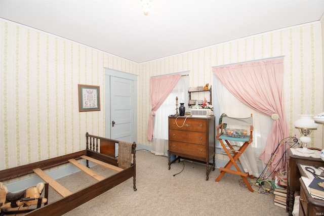 bedroom with light carpet, baseboards, and wallpapered walls