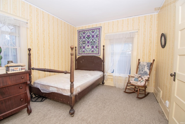 bedroom featuring light carpet and wallpapered walls