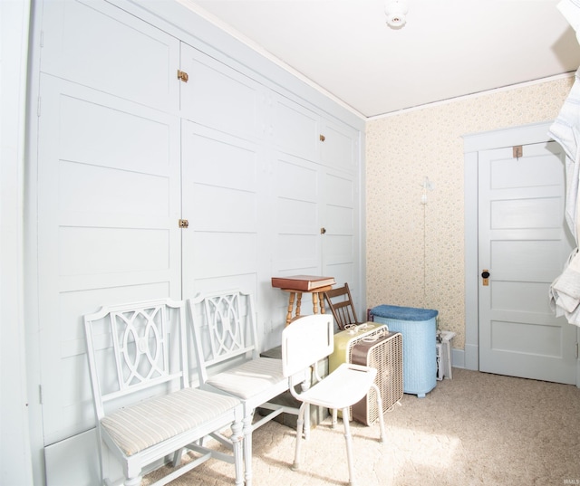 interior space featuring light colored carpet and wallpapered walls