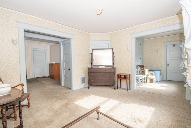 bedroom with light carpet and wallpapered walls