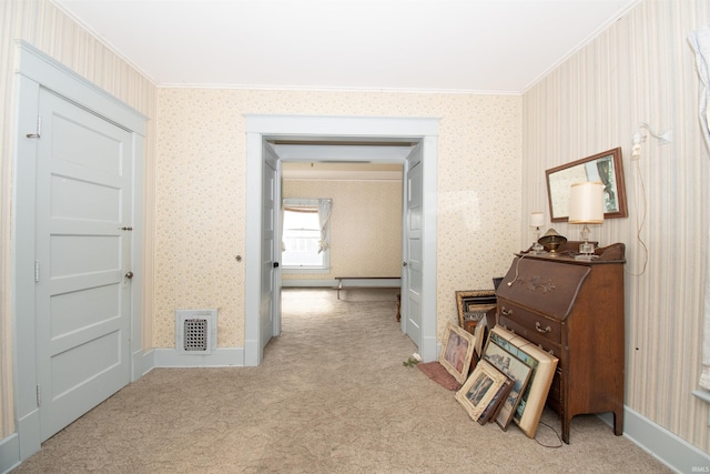 corridor featuring light carpet, crown molding, visible vents, and wallpapered walls