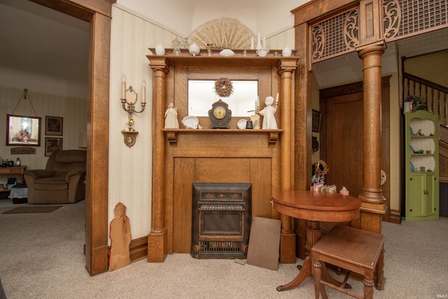 living area with carpet floors and decorative columns