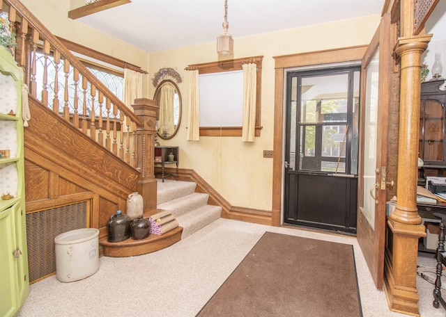 entryway with stairway and baseboards