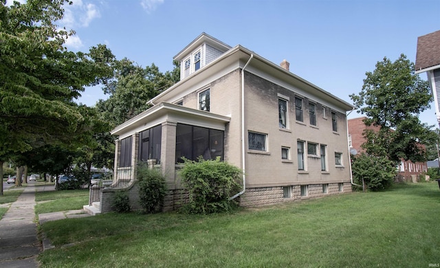 view of property exterior featuring a sunroom, a yard, and a chimney