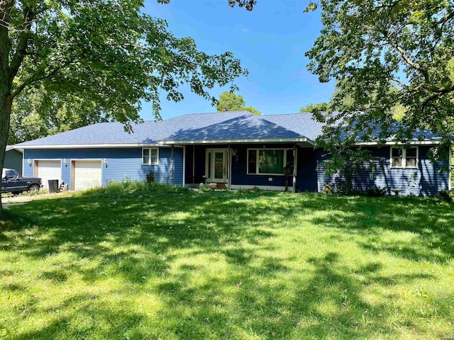 single story home featuring a garage and a front yard