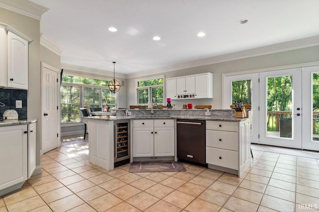 kitchen with white cabinets, beverage cooler, a healthy amount of sunlight, and dishwasher