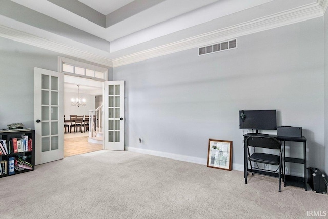 home office featuring an inviting chandelier, french doors, crown molding, a raised ceiling, and light colored carpet