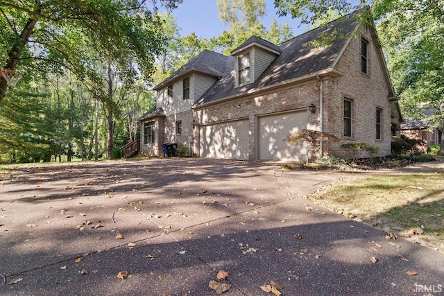 view of side of home featuring a garage