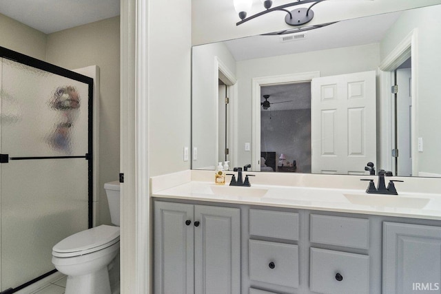 bathroom featuring a shower with shower door, toilet, tile patterned flooring, and vanity