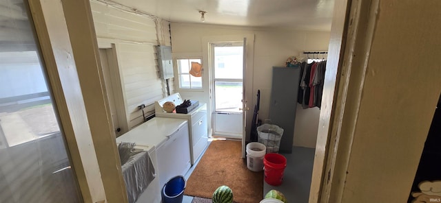 bathroom featuring vaulted ceiling, washing machine and dryer, and electric panel