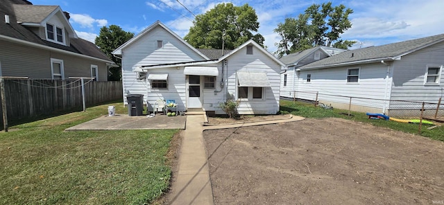 back of house featuring a lawn