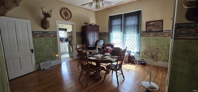 dining room with ceiling fan, ornamental molding, and wood-type flooring