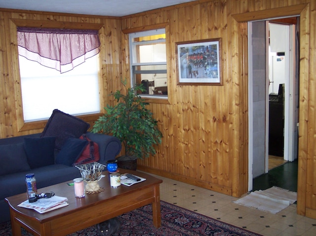 living room with wood walls and tile patterned floors