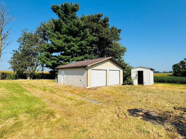 garage featuring a lawn