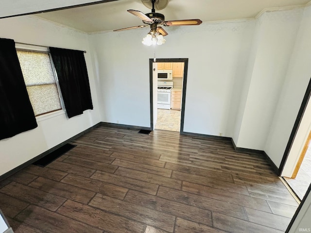 unfurnished room featuring ceiling fan, crown molding, and dark hardwood / wood-style flooring