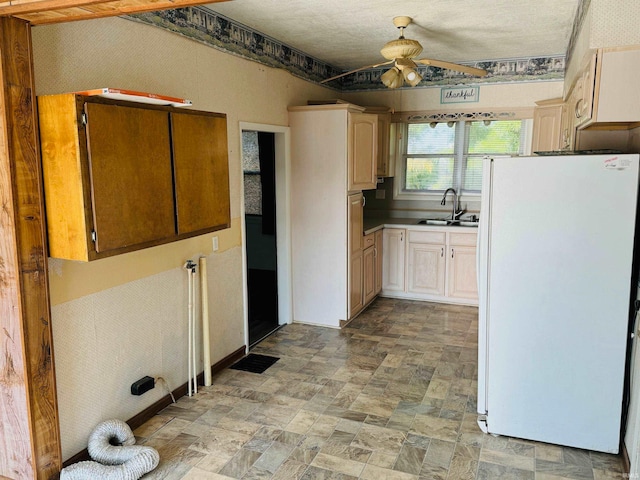 kitchen with sink, a textured ceiling, ceiling fan, light tile patterned flooring, and white refrigerator