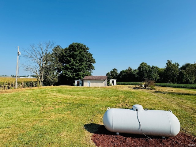 view of yard with an outbuilding and a rural view