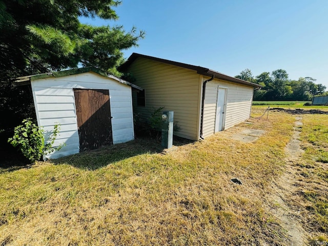 view of outdoor structure with a lawn