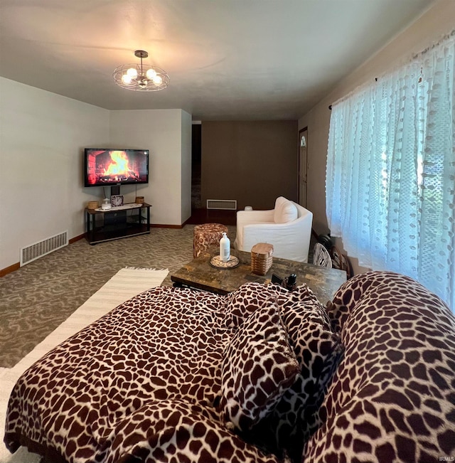 carpeted bedroom featuring an inviting chandelier