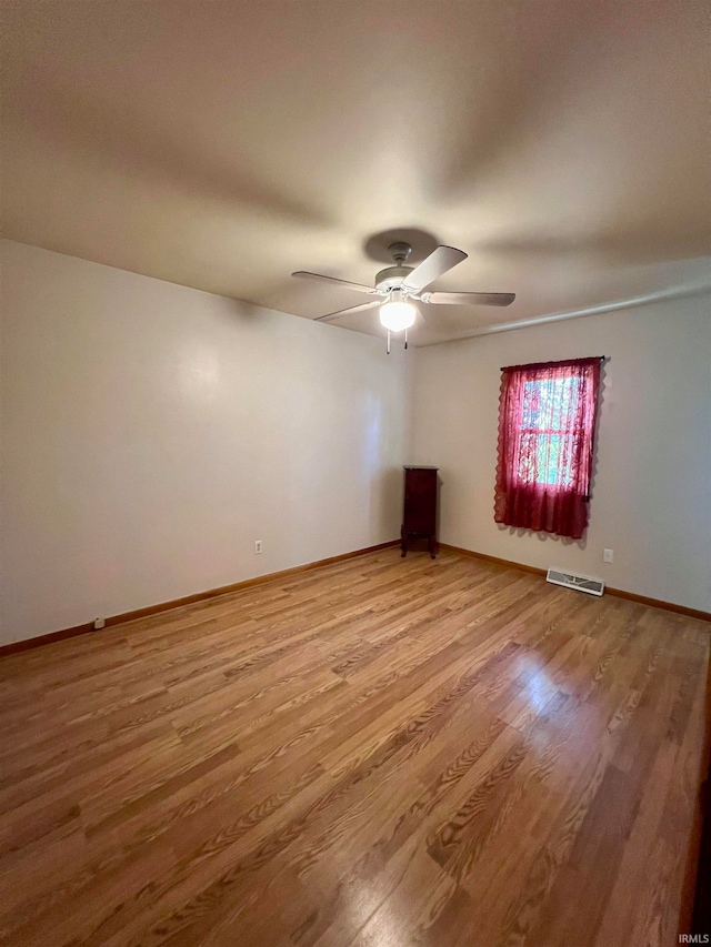 unfurnished room with hardwood / wood-style flooring and ceiling fan