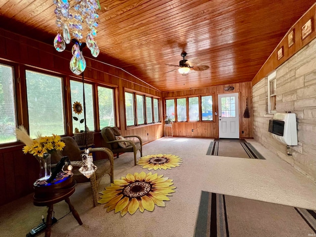 unfurnished sunroom featuring ceiling fan, vaulted ceiling, and wooden ceiling