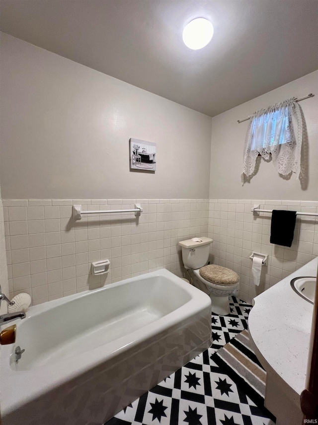 bathroom featuring a bathing tub, toilet, tile patterned floors, and tile walls