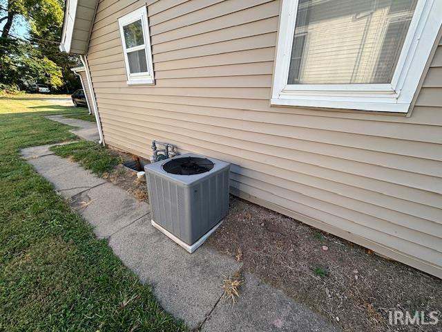 view of side of home with central air condition unit