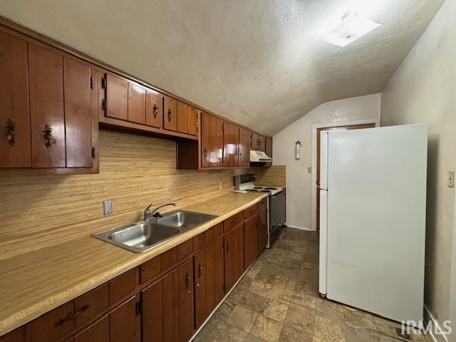 kitchen featuring electric range oven, freestanding refrigerator, light countertops, under cabinet range hood, and a sink