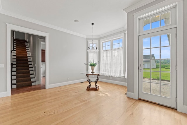 unfurnished dining area featuring a chandelier, ornamental molding, and baseboards
