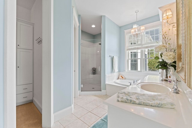 bathroom with a sink, a stall shower, tile patterned flooring, a chandelier, and a garden tub