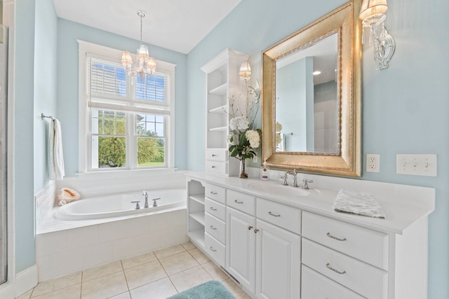 bathroom featuring vanity, a notable chandelier, a garden tub, and tile patterned floors