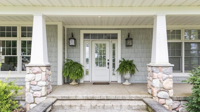 view of exterior entry with a porch