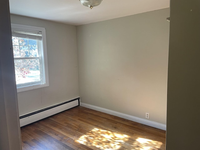 11585 E 565 N, Orland, IN 46776 - unfurnished room with wood finished floors, baseboards, and a baseboard heating unit