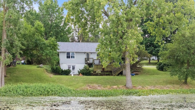 11585 E 565 N, Orland, IN 46776 - view of front of house featuring stairs, a wooden deck, roof with shingles, and a front lawn
