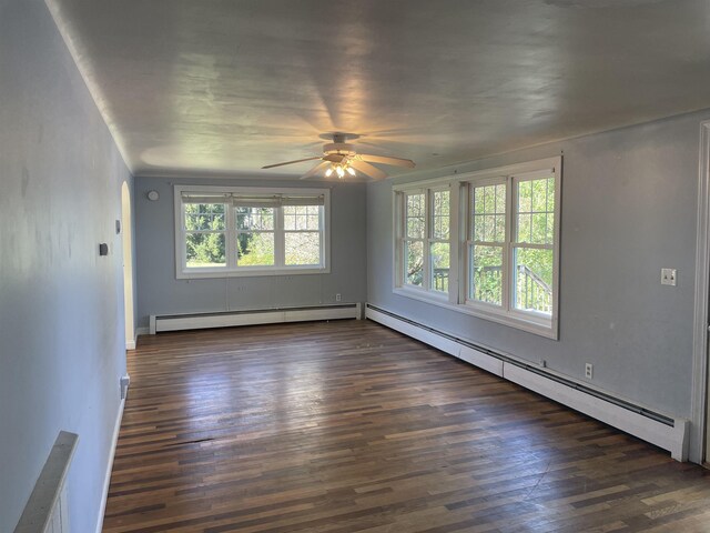 11585 E 565 N, Orland, IN 46776 - empty room featuring baseboards, a ceiling fan, baseboard heating, and dark wood finished floors