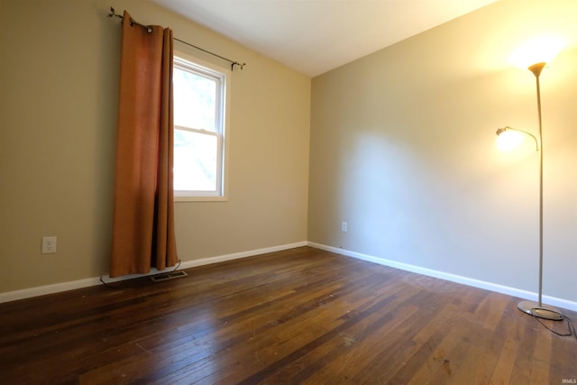 empty room with dark wood-type flooring