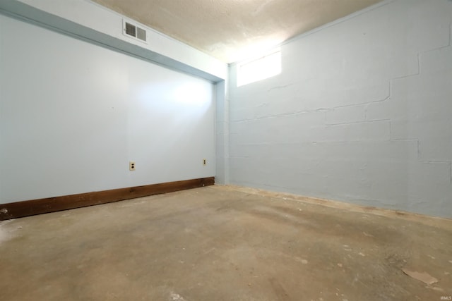 basement featuring a textured ceiling