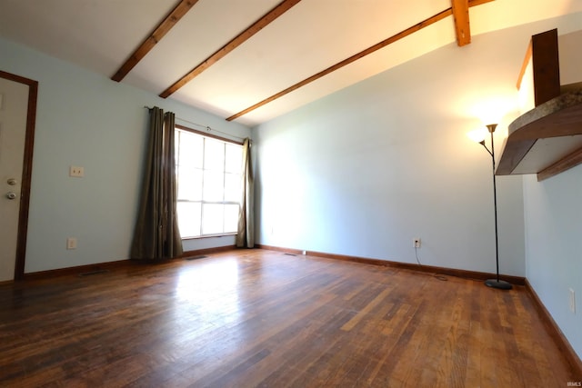 empty room featuring vaulted ceiling with beams and dark hardwood / wood-style floors