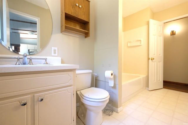 bathroom featuring a washtub, tile patterned floors, toilet, and vanity