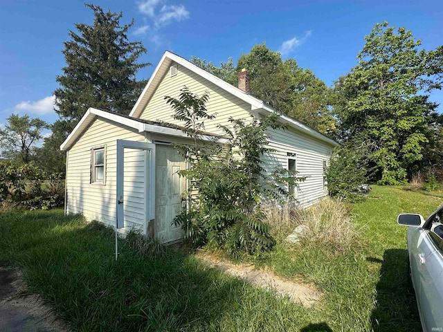 view of property exterior with a yard