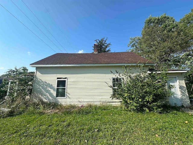 view of side of property with a lawn