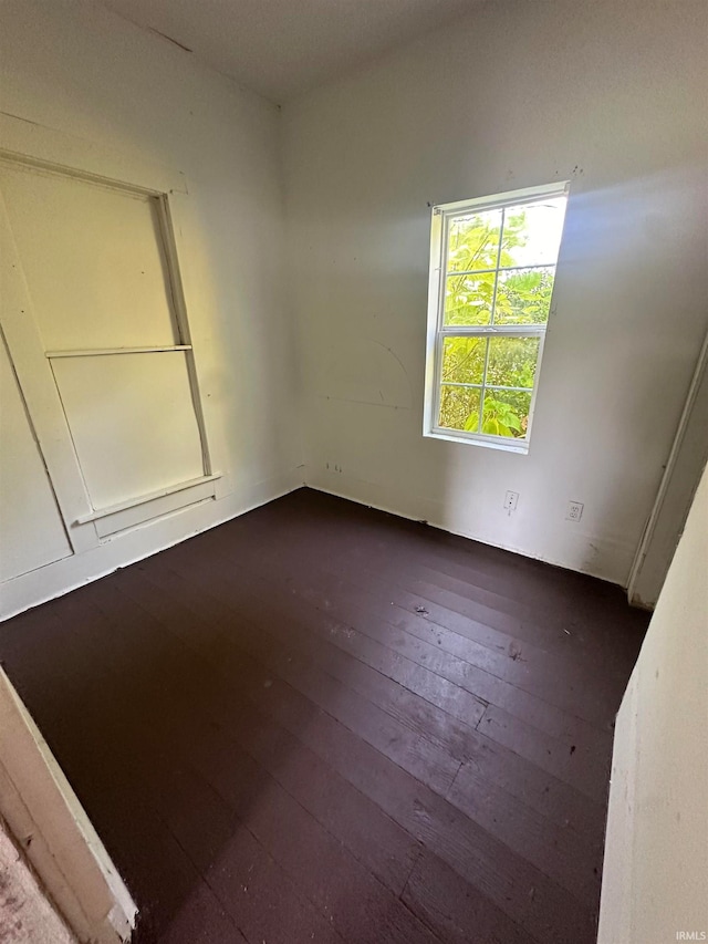 unfurnished room featuring dark hardwood / wood-style floors