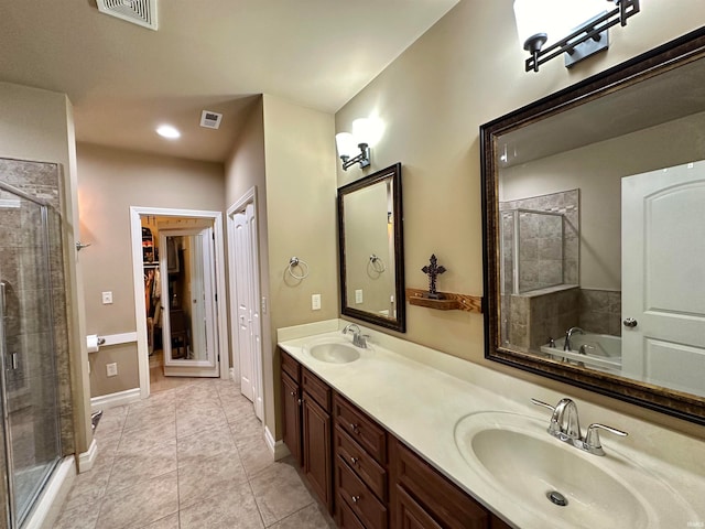 bathroom featuring tile patterned floors, independent shower and bath, and vanity