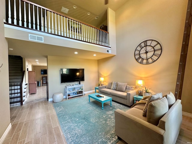 living room featuring hardwood / wood-style floors and a high ceiling