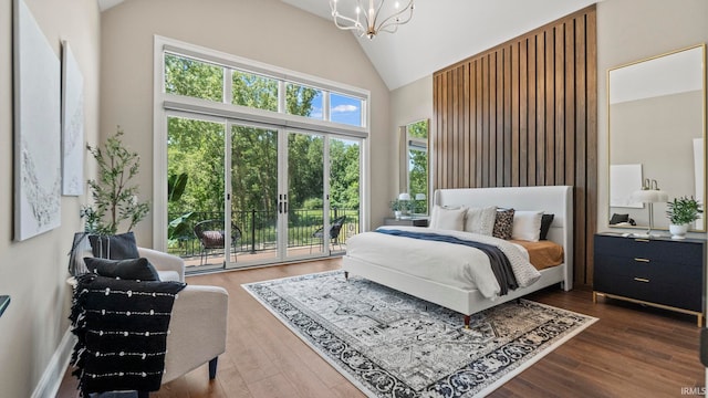 bedroom featuring a chandelier, access to outside, high vaulted ceiling, and wood finished floors