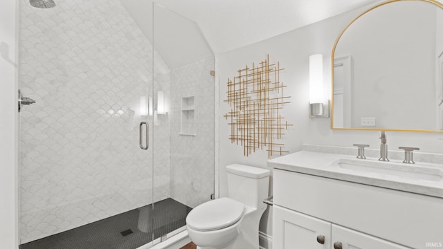 bathroom with vaulted ceiling, vanity, toilet, and a shower stall