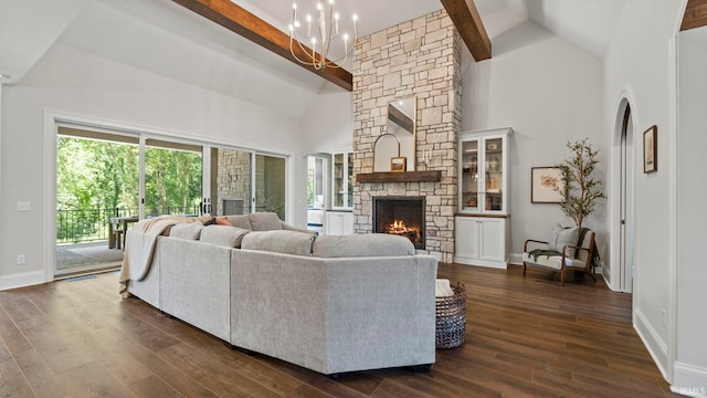 living room featuring high vaulted ceiling, beamed ceiling, dark wood-type flooring, and a stone fireplace