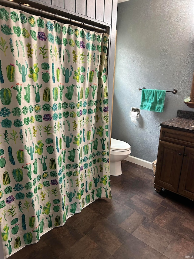 bathroom featuring vanity, toilet, and curtained shower