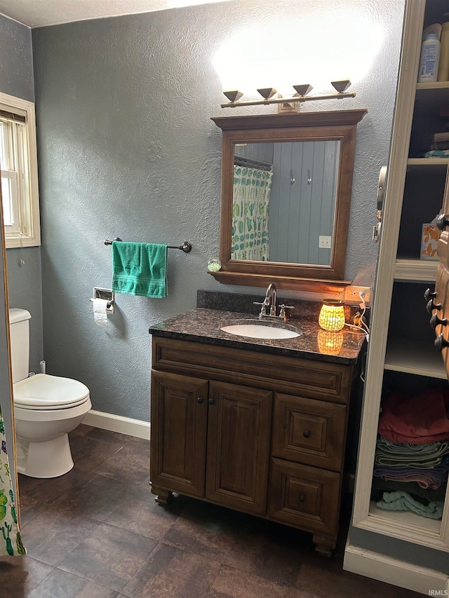 bathroom with vanity, toilet, and tile patterned floors